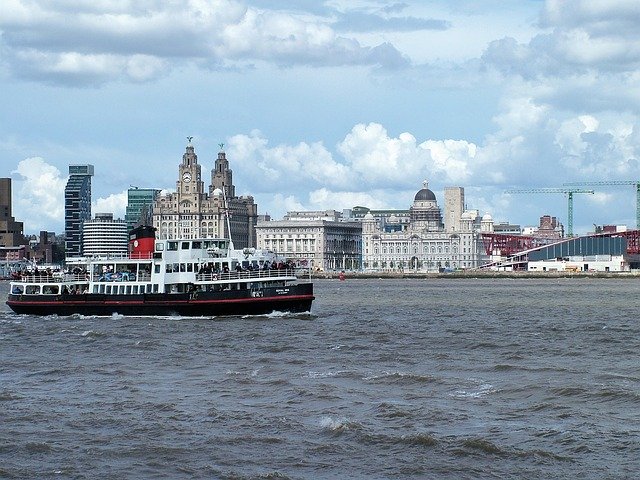 Liverpool Ferry crossing the Mersey with the 3 graces in the background